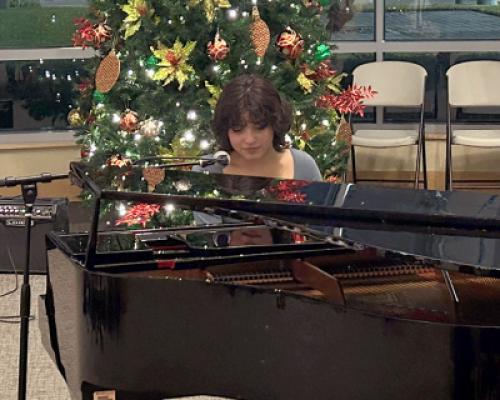 Brain tumor survivor Vania Q playing the piano